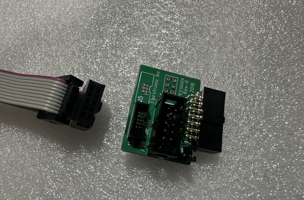 AVR adapter (14 to 10 pins PN: PE036X04 ) and one 10-pins ribbon cable.